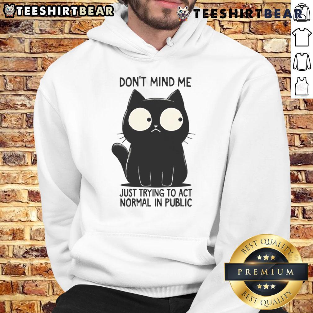 Funny cat in a hoodie, looking quirky and trying to act normal in public, showcasing playful feline antics.