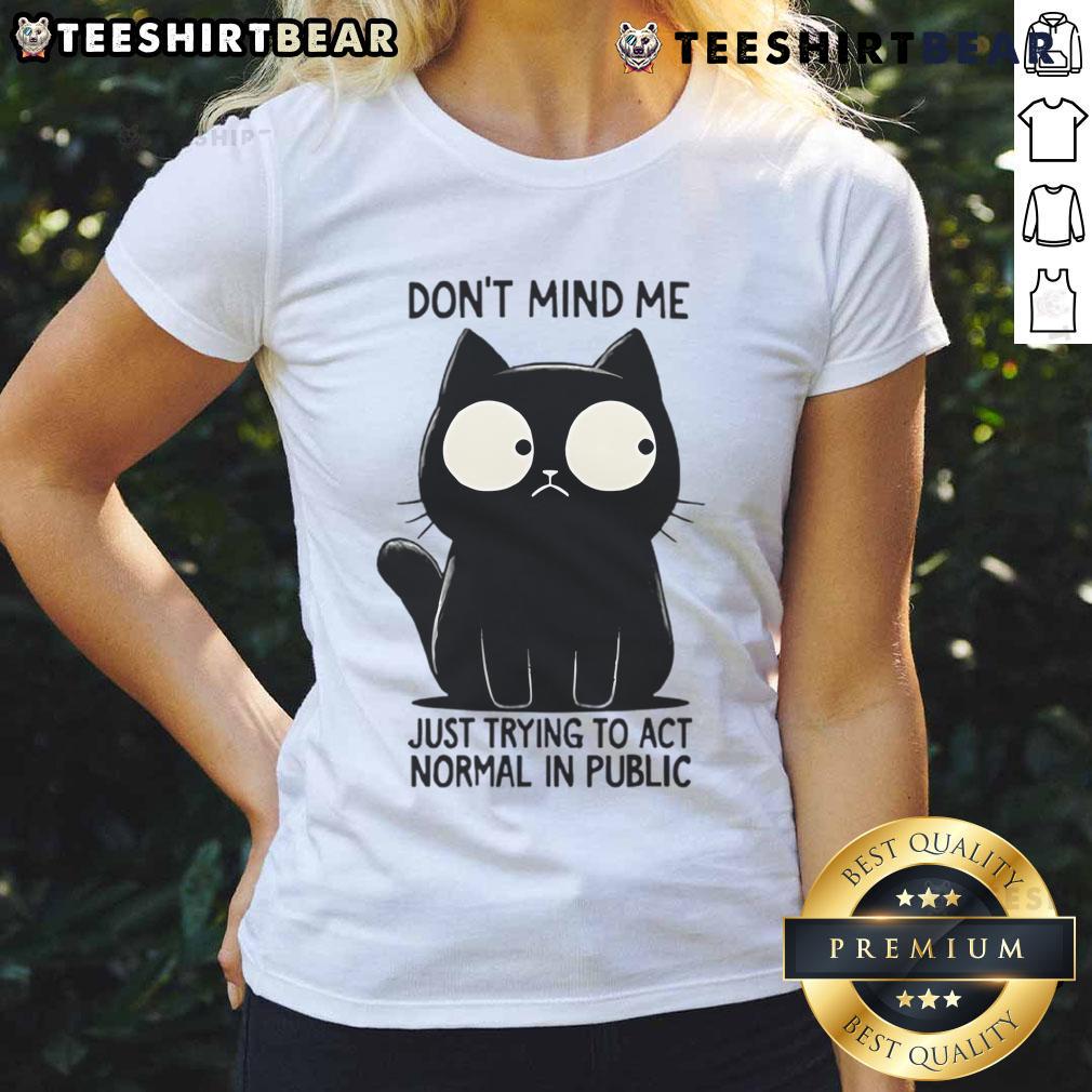 Funny cat in a public setting, pretending to act normal, featured on a ladies tee design. Perfect for cat lovers!