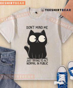 Funny cat in a washed T-shirt, humorously trying to act normal in public, showcasing its quirky personality.