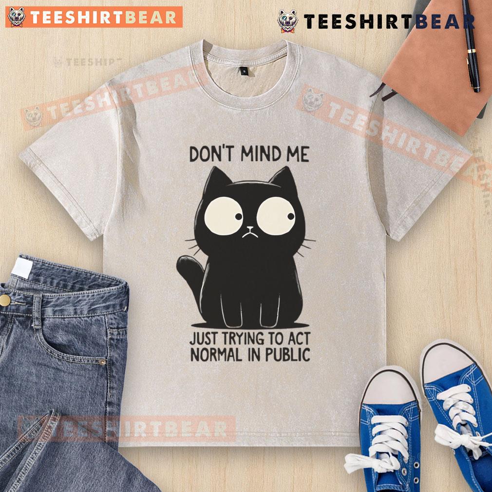 Funny cat in a washed T-shirt, humorously trying to act normal in public, showcasing its quirky personality.