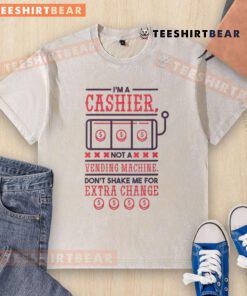 Funny I'm A Cashier Not A Vending Machine t-shirt, humorously warning customers against shaking for extra change.