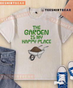Funny 'The Garden Is My Happy Place' gardening wheelbarrow washed t-shirt displayed on a rustic background.