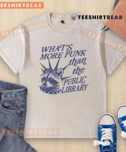 Vintage raccoon graphic on a washed t-shirt, humorously asking 'What's more punk than the public library?'
