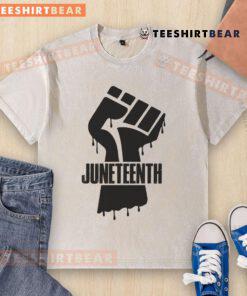 Black fist graphic on a washed T-shirt celebrating Juneteenth, symbolizing freedom and empowerment.