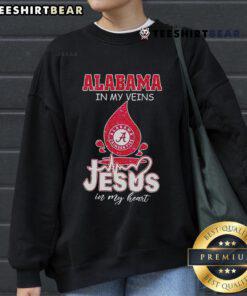 Nice Alabama In My Veins Jesus In My Heart Sweatshirt in a cozy setting, perfect for faith and state pride.