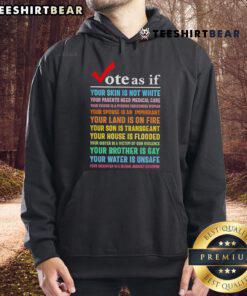 Premium hoodie with the message 'Vote As If Your Skin Is Not White' advocating for social justice and healthcare access.