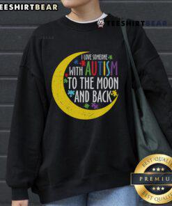 Cozy sweatshirt featuring 'Love Someone With Autism To The Moon and Back' design with puzzle piece graphic.