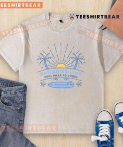 Pretty Paradise Line Feel Free To Cross washed t-shirt in vibrant colors displayed on a rustic wooden background.