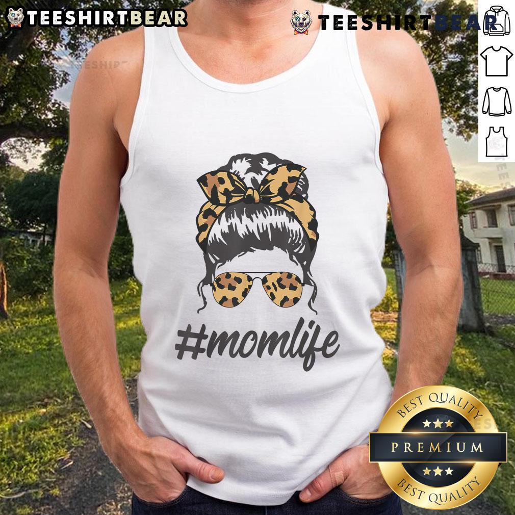 Stylish mom in leopard-pattern shades and a tank top, sporting a cool messy bun, embracing top-classy mom life.