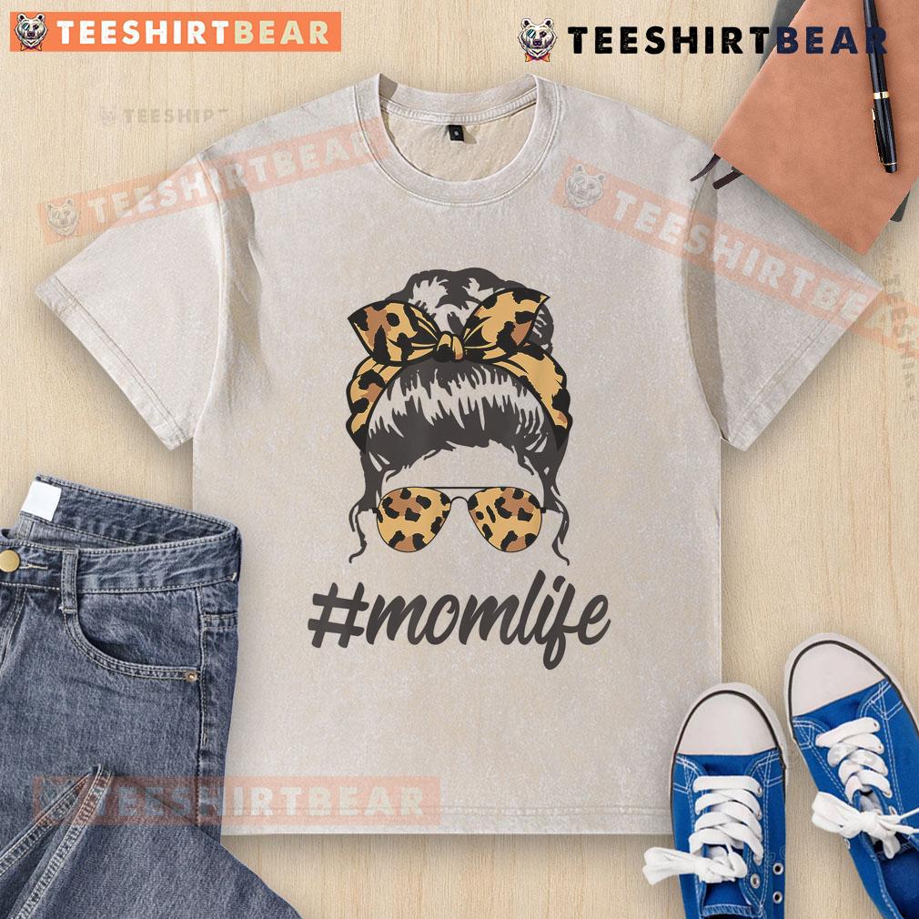Stylish mom in a washed T-shirt and leopard pattern shades, rocking a cool messy bun, embodying top-classy mom life.