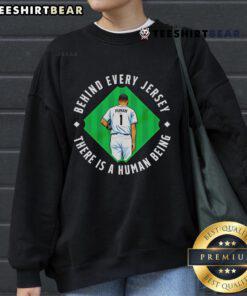 Top Human Behind The Jersey Sweatshirt showcasing a stylish design with motivational text for sports enthusiasts.