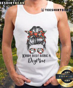 Dog mom in a messy bun wearing a tank top with 'Top Kinda Busy Being A Dog Mom' slogan, smiling with her dog.
