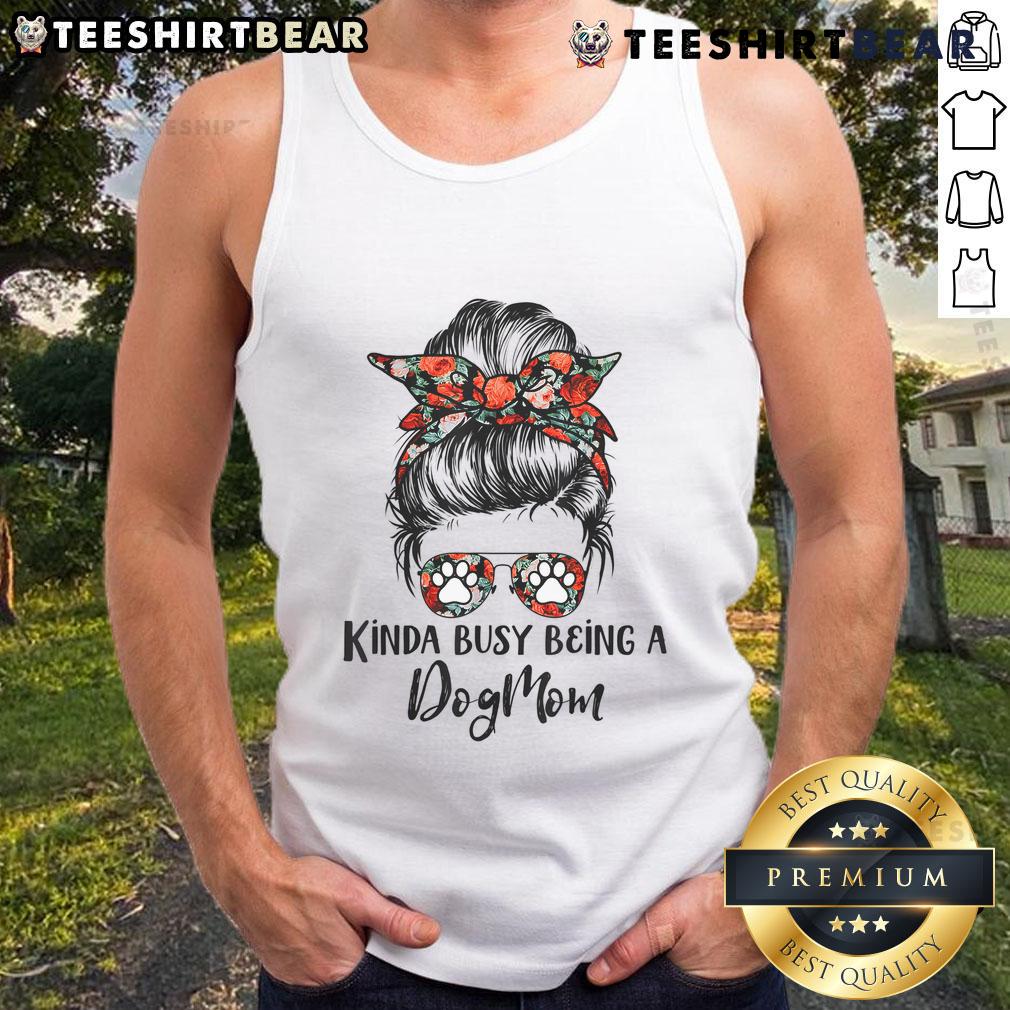 Dog mom in a messy bun wearing a tank top with 'Top Kinda Busy Being A Dog Mom' slogan, smiling with her dog.