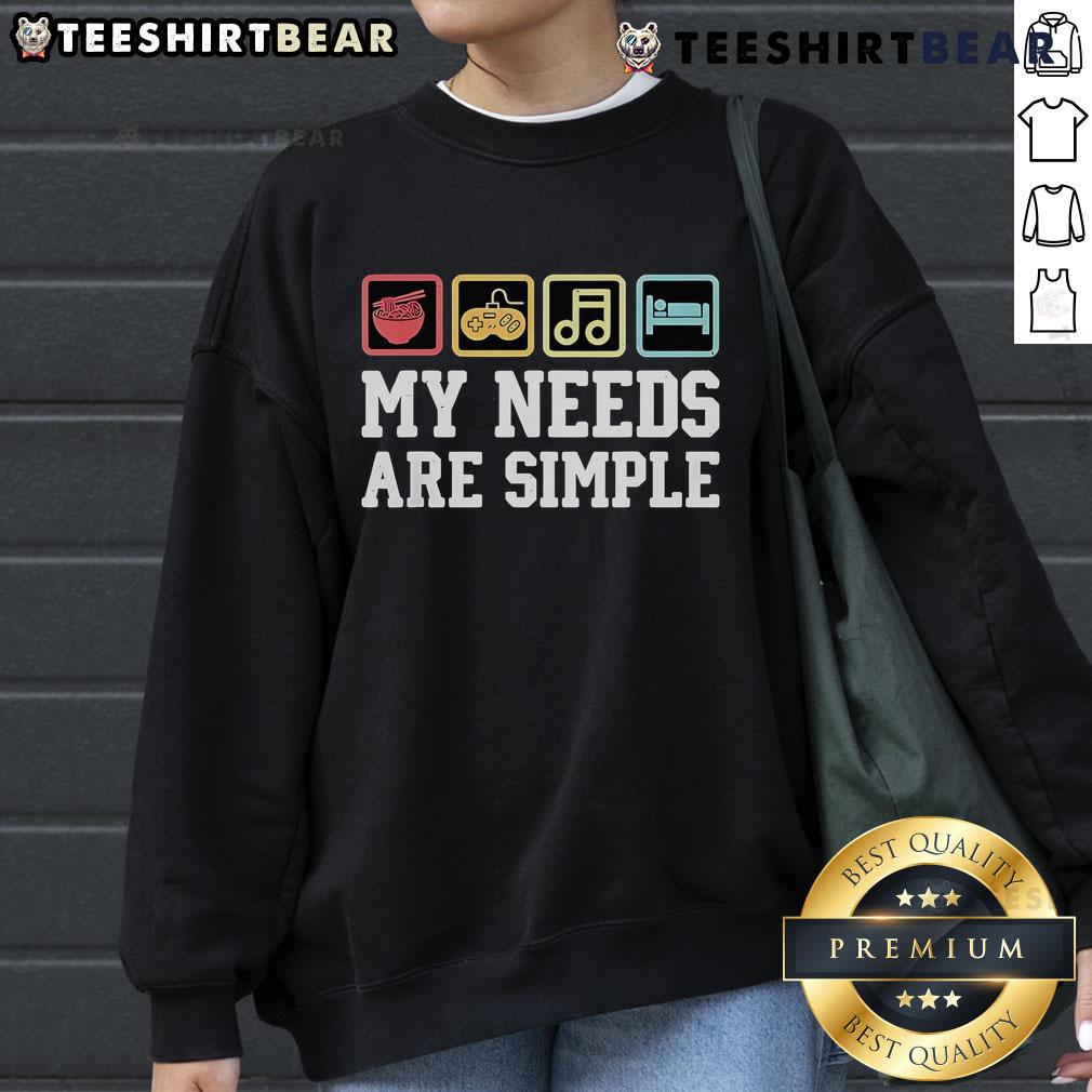 Alt Text: Cozy sweatshirt featuring My Needs Are Simple: Ramen, Video Games, Music, Sleep design for gamers and comfort lovers.