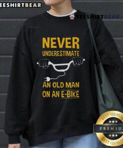 Alt Text: Top Never Underestimate An Old Man On An E-Bike Sweatshirt featuring a vintage design and comfortable fit.