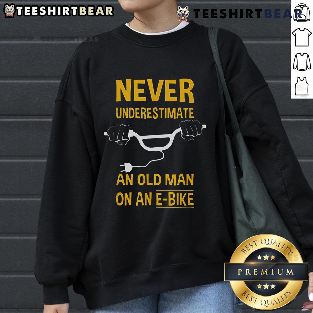 Alt Text: Top Never Underestimate An Old Man On An E-Bike Sweatshirt featuring a vintage design and comfortable fit.