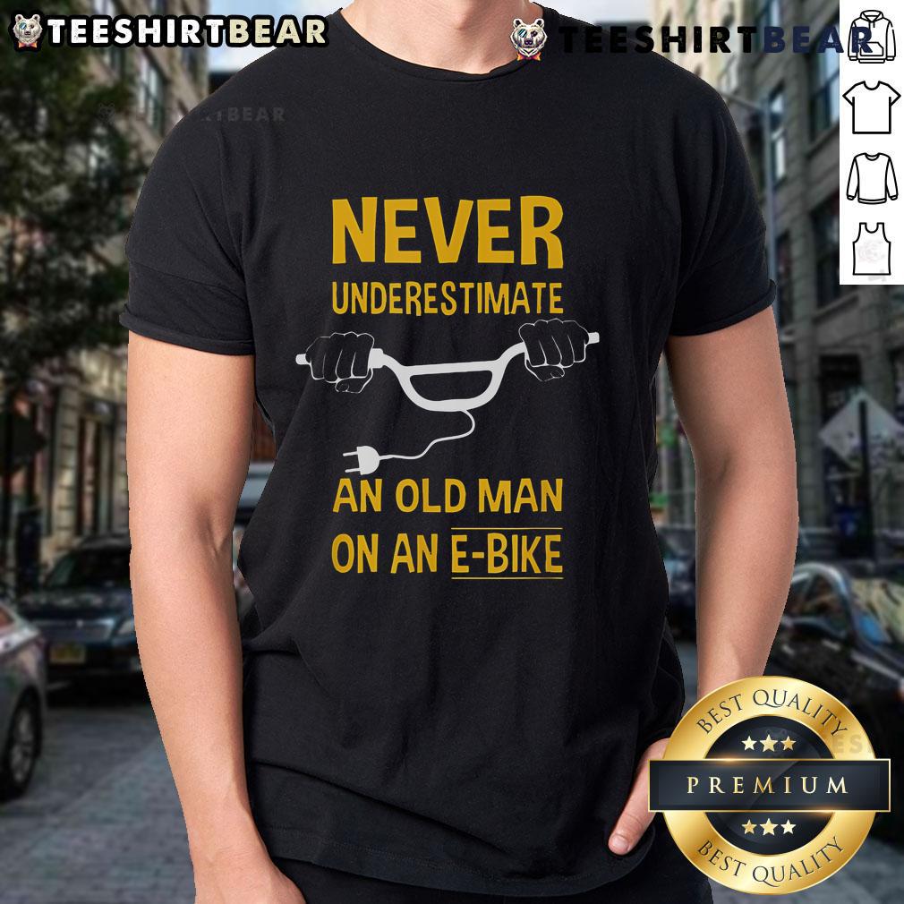 Top Never Underestimate An Old Man On An E-Bike T-Shirt design featuring a vintage graphic of an e-bike and bold text.