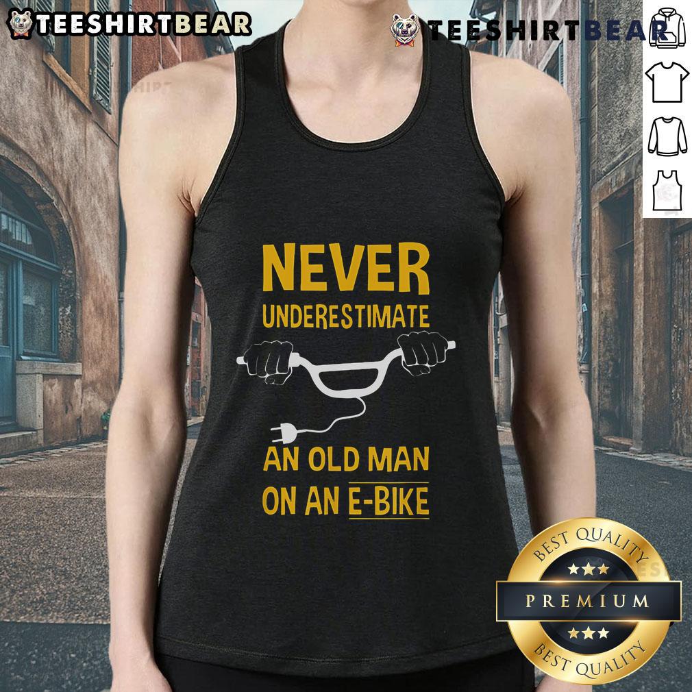 Man wearing 'Never Underestimate An Old Man On An E-Bike' tank top, showcasing confidence and style on an electric bike.