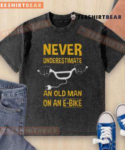 Top Never Underestimate An Old Man On An E-Bike Washed T-Shirt featuring a bold graphic and comfortable fit.