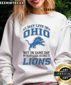 Ohio fan wearing Detroit Lions sweatshirt, showcasing team spirit on game day with vibrant colors and bold logo.