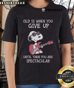 Awesome Snoopy guitar design on a ladies tee with the quote about aging and staying spectacular. Perfect for music lovers!
