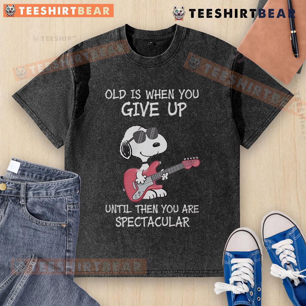 Awesome Snoopy guitar design on a washed t-shirt with 'Old is when you give up' quote, perfect for music lovers.