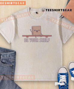 Cute Be Your Shelf Washed T-Shirt displayed on a wooden shelf, showcasing its soft fabric and trendy design. Perfect for casual wear.