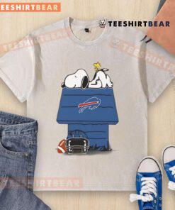 Alt Text: Cute Buffalo Bills football Snoopy and Woodstock design on a washed t-shirt, perfect for Peanuts fans and sports lovers.