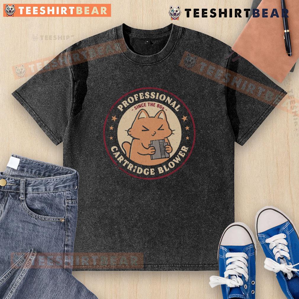 Cute cat graphic on a washed T-shirt featuring 'Pro Cartridge Blower Since the 80s' design for cat lovers.