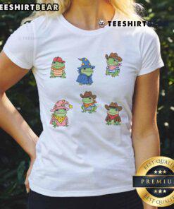 Cute frogs dressed as cowboys and witches on a ladies tee, perfect for frog lovers and Halloween enthusiasts.