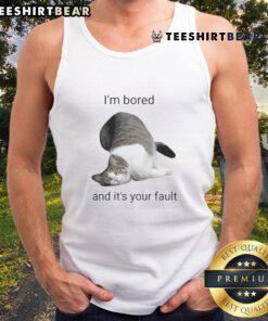 Funny cat in a tank top with a bored expression, captioned 'I'm bored and it's your fault,' perfect for cat lovers.