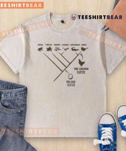 Funny evolution diagram of the chicken and the egg on a washed T-shirt, showcasing humor and clever design.