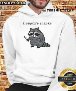 Alt Text: Raccoon in a hoodie holding a knife with a humorous expression, captioned Funny I Require Snacks for hoodie lovers.