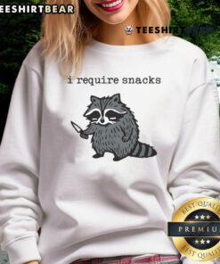 Funny 'I Require Snacks' raccoon with knife sweatshirt design, perfect for animal lovers and humor enthusiasts.