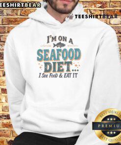 Alt Text: Humorous 'I'm On A Seafood Diet - I See Food, Eat It' hoodie featuring bold text design, perfect for food lovers.