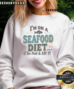 Alt Text: Funny I'm On A Seafood Diet I See Food, Eat It sweatshirt featuring humorous seafood-themed design.