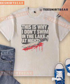 Funny 'This Is Why I Dont Swim In The Lake At Night' t-shirt with killer knife graphic, perfect for humor lovers.