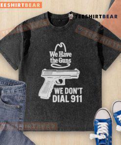 Funny 'We Have The Guns, We Don't Dial 911' washed t-shirt displayed on a wooden background, perfect for casual wear.