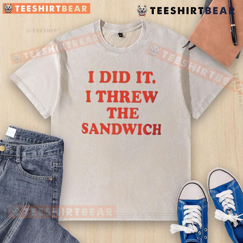 Child proudly shows off a washed T-shirt after throwing a sandwich, capturing the moment of fun and mischief.