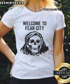 Happy skull graphic on a ladies tee, welcoming you to Fear City with a fun and edgy design for Halloween enthusiasts.
