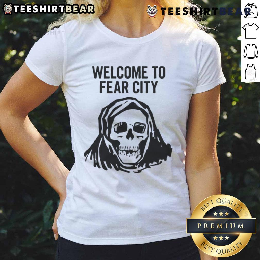 Happy skull graphic on a ladies tee, welcoming you to Fear City with a fun and edgy design for Halloween enthusiasts.