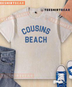 Nice cousins wearing beach-washed t-shirts, enjoying a sunny day by the ocean, showcasing vibrant summer style.