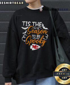 Alt Text: Cozy 'Tis The Season To Be Spooky' Kansas City Chiefs sweatshirt perfect for Halloween celebrations and game day.