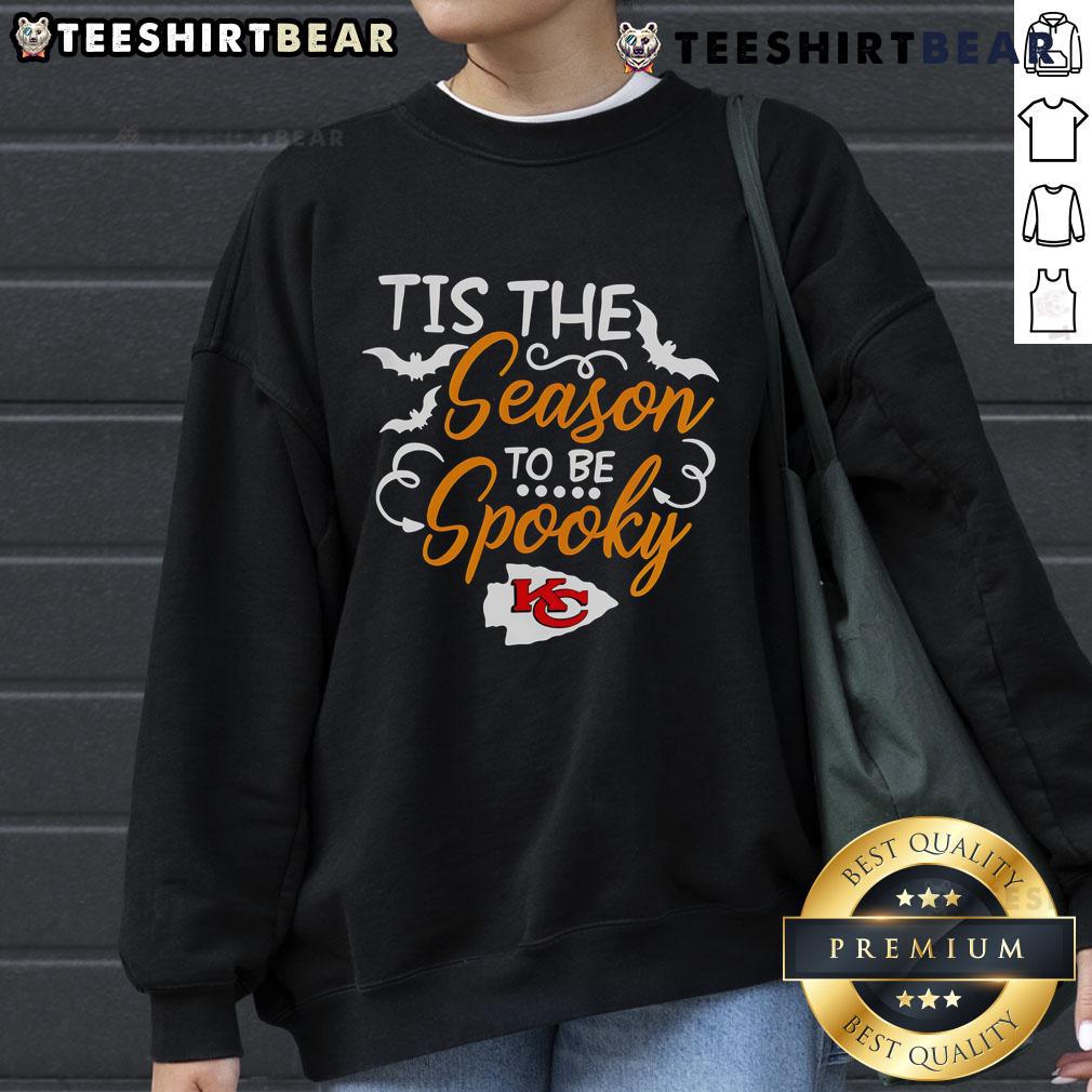 Alt Text: Cozy 'Tis The Season To Be Spooky' Kansas City Chiefs sweatshirt perfect for Halloween celebrations and game day.
