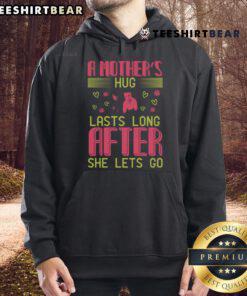 Cozy hoodie featuring 'A Mother's Hug Lasts Long After She Lets Go' design, perfect for expressing love and warmth.
