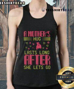 Girl in a tank top enjoying a warm hug, showcasing the sentiment that a mother's hug lasts long after she lets go.
