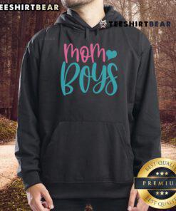 Mom wearing a stylish hoodie with her two boys, showcasing a cozy family moment in a vibrant outdoor setting.