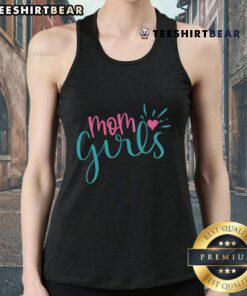 Pretty mom and daughter wearing matching tank tops, enjoying a sunny day outdoors together, showcasing stylish family fashion.