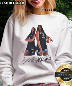 Alt Text: Angel Reese and Kamilla Cardoso wearing Chicago Sky signature sweatshirt, showcasing team spirit and style.
