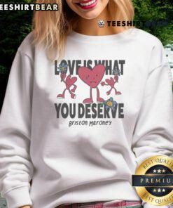 Alt Text: Cozy 'Love Is What You Deserve' sweatshirt by Briston Maroney featuring sad and happy hearts design.